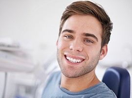 Man in dental chair with flawless smile after dental bonding