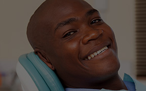 Smiling man in dental chair after T M J treatment