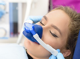 Woman with nitrous oxide sedation dentistry nasal mask