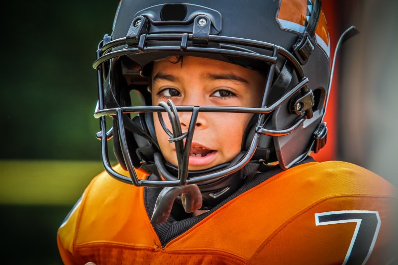 child in a football helmet